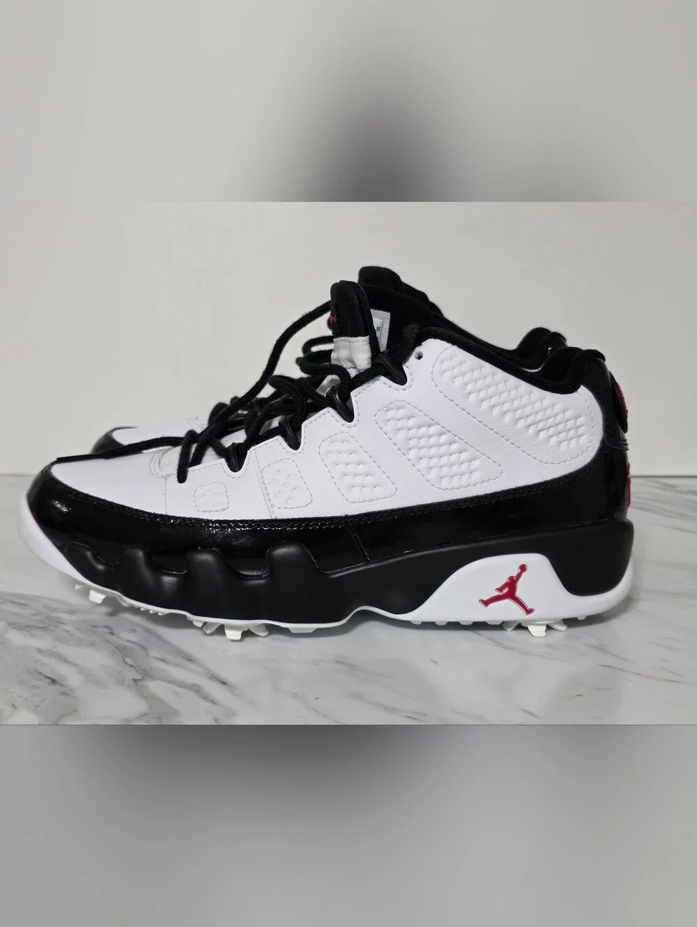 Jordan White and Black Golf Cleats with Red Logo